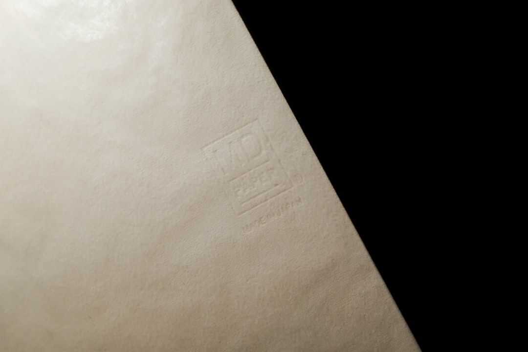 Nahaufnahme des Wasserzeichens "MD Paper Made in Japan" auf beigefarbenem Papier.